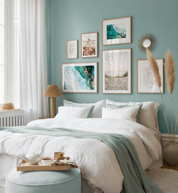 Tropical gallery wall with beach posters and photographs with oak frames for bedroom