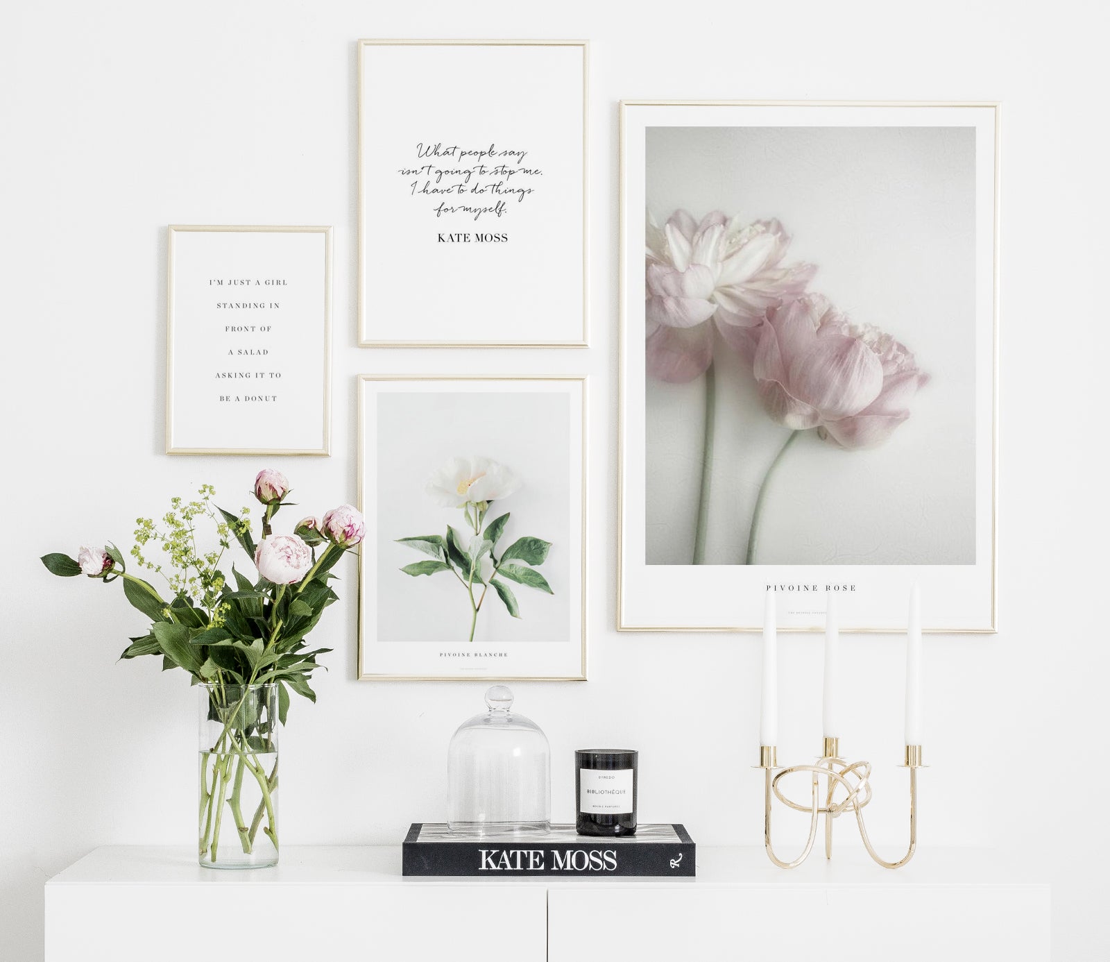 Stylish gallery wall with fasion posters in gold frames